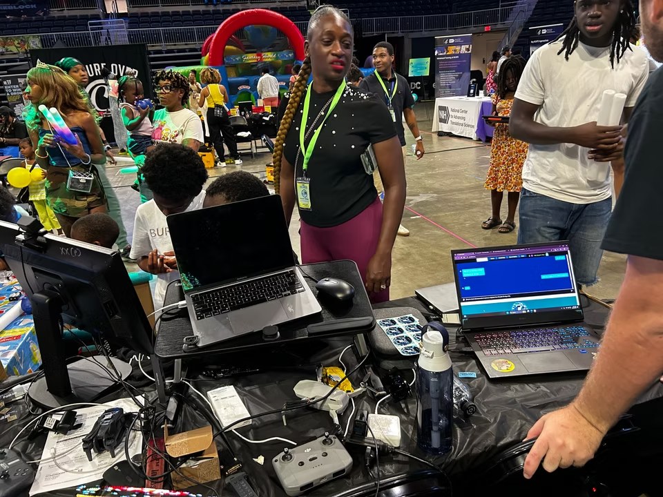 Families and young builders gathering around the ZEN technology table