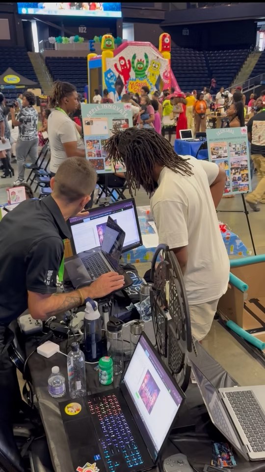 ZEN AI team member demonstrating software on a laptop to event participants